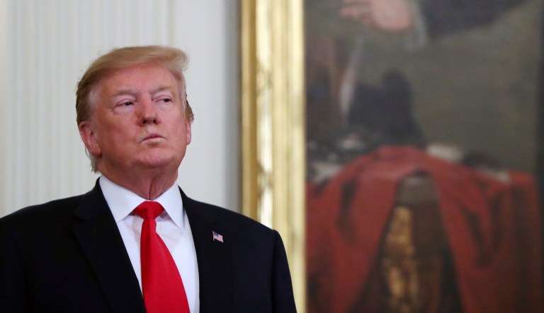 President Trump stands near a portrait of George Washington at a Wounded Warrior Project Soldier Ride event in the East Room of the White House, Thursday, April 18, 2019, in Washington. 