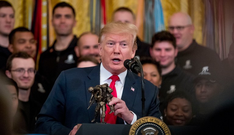 President Donald Trump holds a statue of the Wounded Warrior Project logo as he speaks at a Wounded Warrior Project Soldier Ride event in the East Room of the White House, Thursday, April 18, 2019, in Washington.