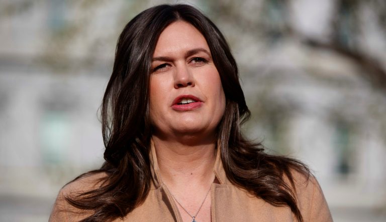 In this April 4, 2019 photo, White House press secretary Sarah Sanders talks with reporters outside the White House in Washington. 