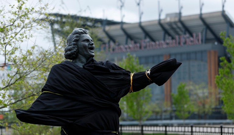 A partially covered statue of singer Kate Smith is seen near the Wells Fargo Center, Friday, April 19, 2019, in Philadelphia. The Philadelphia Flyers covered the statue of singer Kate Smith outside their arena, following the New York Yankees in cutting ties and looking into allegations of racism against the 1930s star with a popular recording of "God Bless America." Flyers officials said Friday they also plan to remove Smithâs recording of âGod Bless Americaâ from their library. They say several songs performed by Smith âcontain offensive lyrics that do not reflect our values as an organization.â