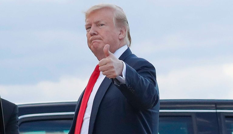 President Donald Trump gives a 'thumbs-up' as he walks across the tarmac during his arrival on Air Force One, Sunday, April 21, 2019, at Andrews Air Force Base, Md. 