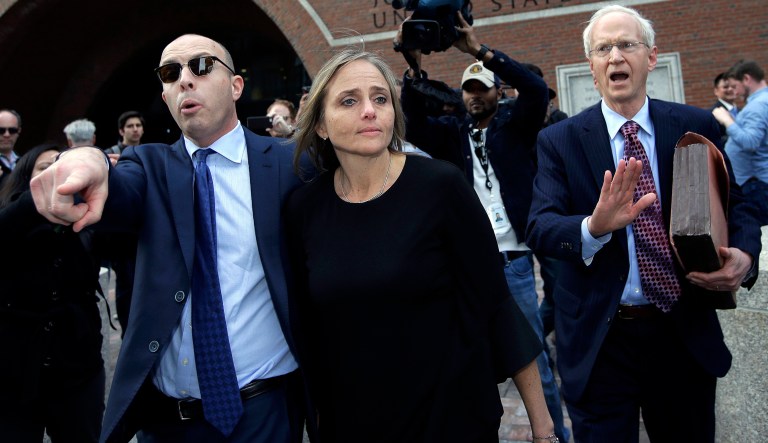 District Court Judge Shelley M. Richmond Joseph, center, departs federal court.