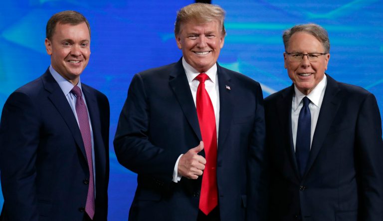 President Donald Trump poses with NRA-ILA Executive Director Chris Cox, left, and executive Vice President Wayne LaPierre before speaking at the National Rifle Association Institute for Legislative Action Leadership Forum in Lucas Oil Stadium in Indianapolis, Friday, April 26, 2019. 