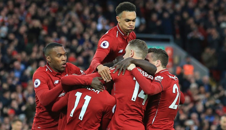 Liverpool teammates celebrate after scoring their side's first goal during the English Premier League soccer match between Liverpool and Huddersfield Town at Anfield Stadium, in Liverpool, England, Friday, April 26, 2019.
