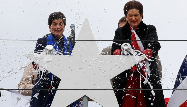 Luci Baines Johnson, left, and her sister, Lynda Johnson Robb, smash champagne bottles to christen the Lyndon B. Johnson, the third Zumwalt-class guided missile destroyer, built at Bath Iron Works, Saturday, April 27, 2019, in Bath, Maine. Johnson and Robb and the daughters of the former president.