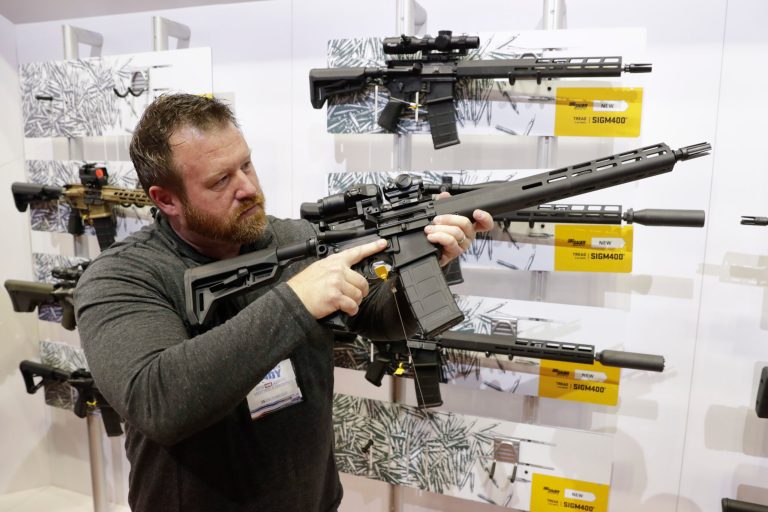 Bryan Oberc, Munster, Ind., tries out an AR-15 from Sig Sauer in the exhibition hall at the National Rifle Association Annual Meeting in Indianapolis, Saturday, April 27, 2019. Modern sporting rifles like the AR-15 are America's top seller.