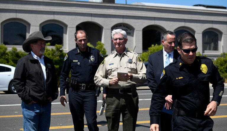 San Diego County Sheriff Bill Gore, center, arrives with other law enforcement officials outside of the Chabad of Poway Synagogue Saturday, April 27, 2019, in Poway, Calif. Several people were injured in a shooting at the synagogue.