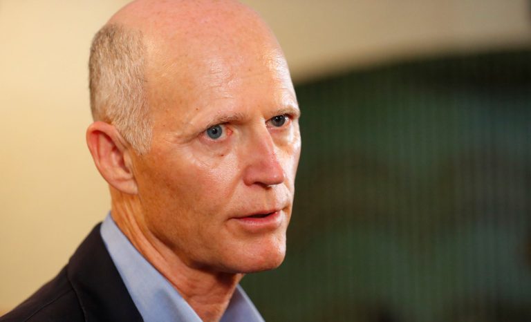 Sen. Rick Scott speaks to members of the media, Monday, April 15, 2019, at El Porton de la Flaca Colombian restaurant in Doral, Florida. 