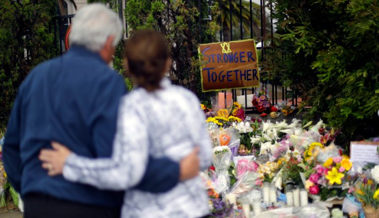 A couple embrace near a growing memorial across the street from the Chabad of Poway synagogue in Poway, Calif., on Monday, April 29, 2019. A 19-year-old gunman opened fire on Saturday as about 100 people were worshipping exactly six months after a mass shooting in a Pittsburgh synagogue, killing one and injuring more. 