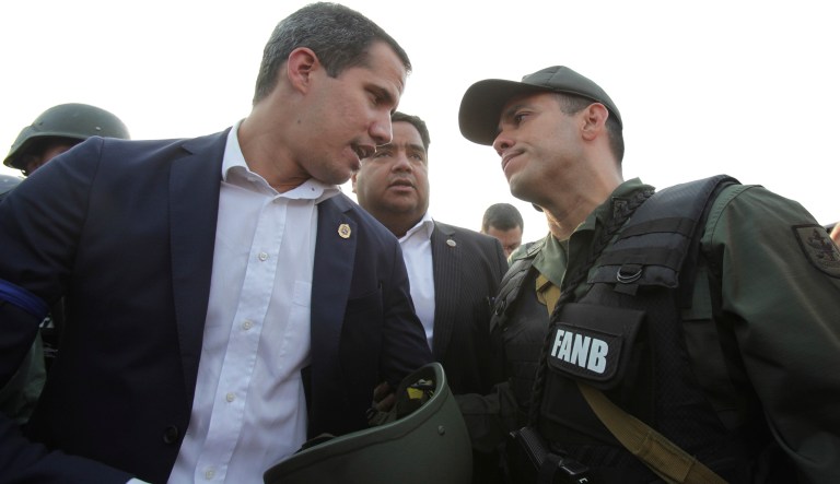 Venezuela's opposition leader and self proclaimed president Juan GuaidÃ³ talks to an Army officer outside La Carlota air base in Caracas, Venezuela, Tuesday, April 30, 2019.