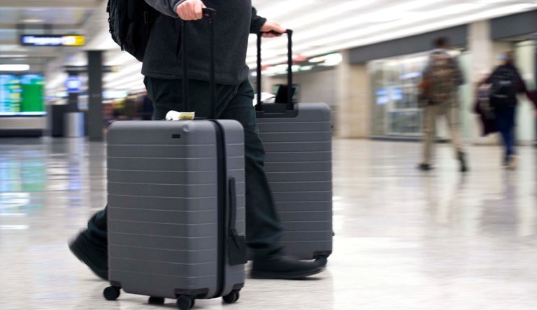 In this March 26, 2019, photo, an airline passenger walk in the arrivals terminal at Dulles International Airport in Dulles, Va.