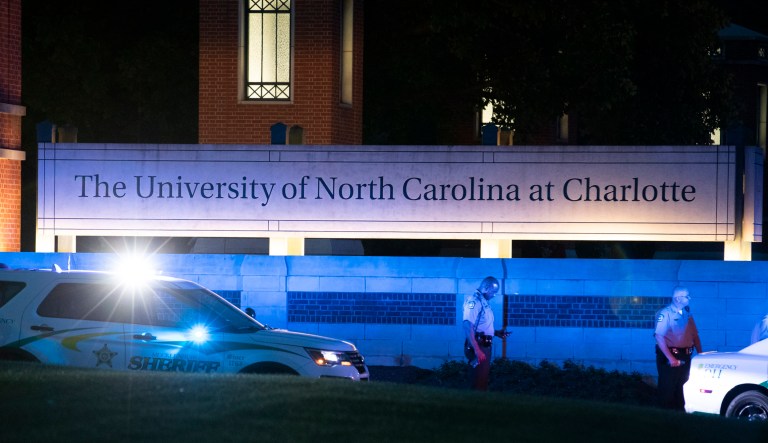Police secure the main entrance to UNC Charlotte after a shooting at the school that left at least two people dead in Charlotte, N.C. 