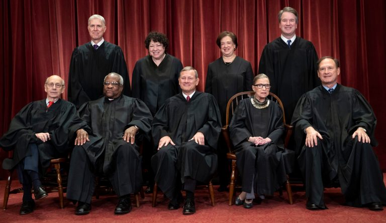 In this Nov. 30, 2018 photo, the justices of the U.S. Supreme Court gather for a formal group portrait to include the new Associate Justice, top row, far right, at the Supreme Court Building in Washington. Seated from left: Associate Justice Stephen Breyer, Associate Justice Clarence Thomas, Chief Justice of the United States John G. Roberts, Associate Justice Ruth Bader Ginsburg and Associate Justice Samuel Alito Jr. Standing behind from left: Associate Justice Neil Gorsuch, Associate Justice Sonia Sotomayor, Associate Justice Elena Kagan and Associate Justice Brett M. Kavanaugh. 