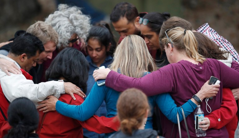 Parents gather in a circle to pray at a recreation center where students were reunited with their parents after a shooting at a suburban Denver middle school Tuesday, May 7, 2019, in Highlands Ranch, Colo.