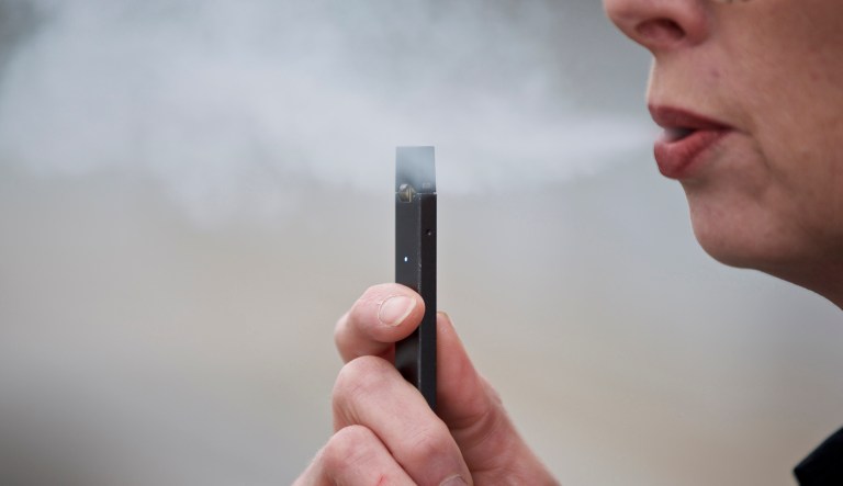 In this April 16, 2019, file photo, a woman exhales a puff of vapor from a Juul pen in Vancouver, Wash.