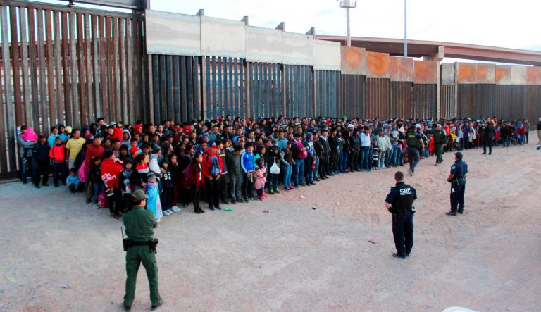 This May 29, 2019 photo released by U.S. Customs and Border Protection shows some of 1,036 migrants who crossed the U.S.-Mexico border in El Paso, Texas, the largest that the Border Patrol says it has ever encountered.