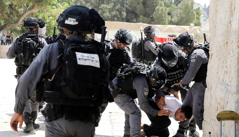 Israeli police officers arrest a Palestinian during clashes with Palestinians by the Dome of the Rock Mosque in the Al Aqsa Mosque compound in Jerusalem's old city on Sunday.