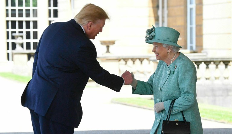 Britain's Queen Elizabeth II greets President Trump as he arrives for a welcome ceremony in the garden of Buckingham Palace in London.