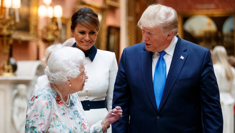 Britain's Queen Elizabeth II speaks to President Trump, right and first lady Melania as they view U.S memorabilia.