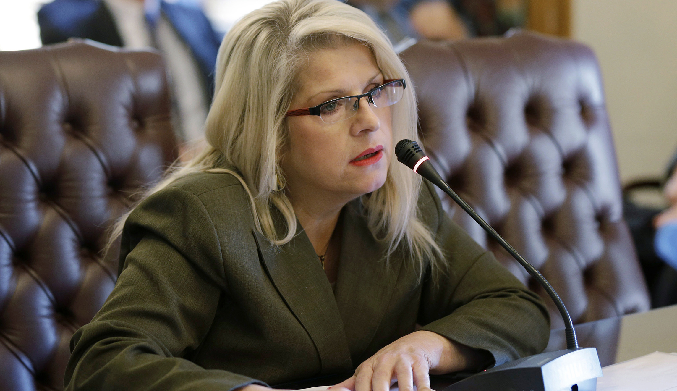 Woman arrested over murder of former state senator shot dead outside her home