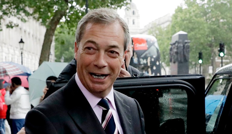 Nigel Farage enters a car in London.