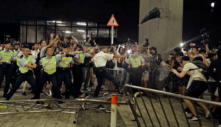 Police officers use pepper spray against protesters in a rally against the proposed amendments to the extradition law at the Legislative Council in Hong Kong during the early hours of Monday, June 10, 2019. 
