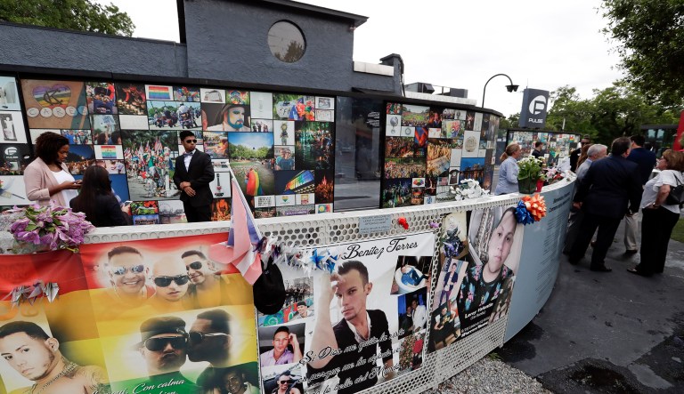 People gather at the Pulse nightclub before a news conference to introduce legislation that would designate the site as a national memorial in Orlando, Fla. 