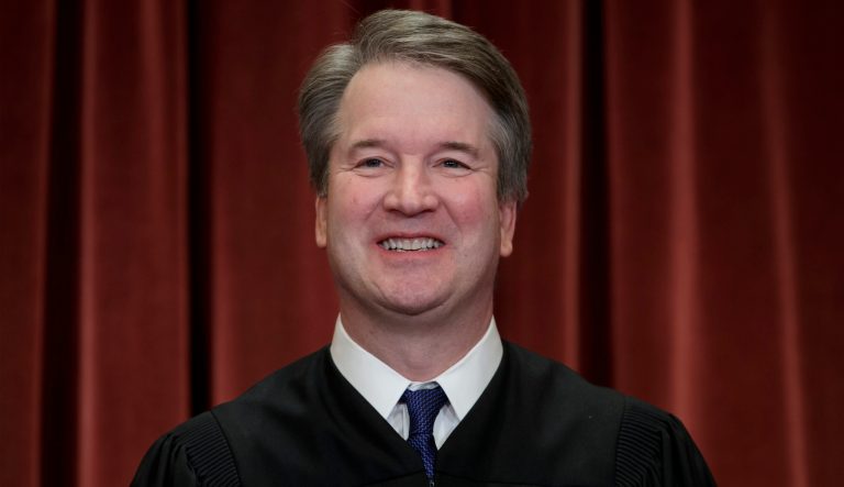 In this Nov. 30, 2018 photo, Associate Justice Brett Kavanaugh sits with fellow Supreme Court justices for a group portrait at the Supreme Court Building in Washington. 