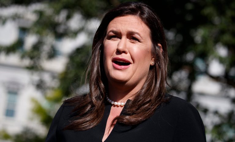 White House press secretary Sarah Sanders talks with reporters outside the White House, Tuesday, June 11, 2019, in Washington. 