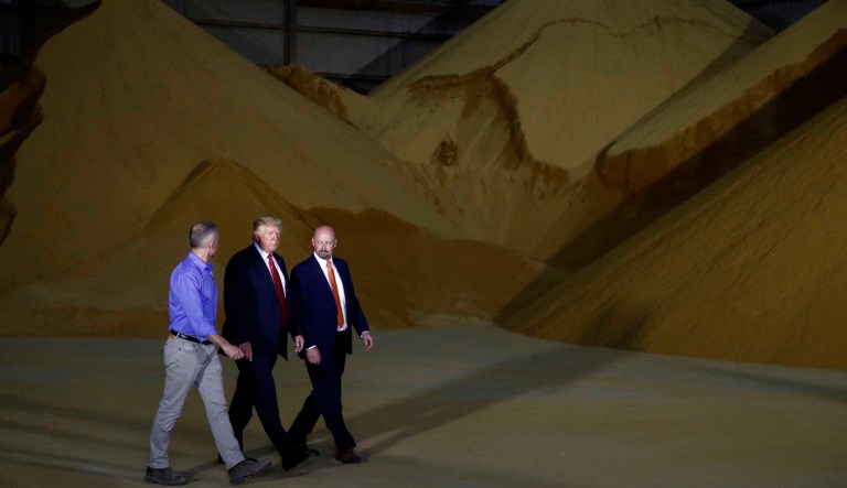 President Donald Trump walks with Geoff Cooper, President and Chief Executive Officer of Renewable Fuels Association, right and Mike Jerke, President and Chief Executive Officer of Southwest Iowa Renewable Energy (SIRE), left, as he tours Southwest Iowa Renewable Energy in Council Bluffs, Iowa, Tuesday, June 11, 2019.