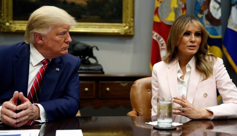 President Trump listens as first lady Melania Trump speaks during a briefing in Washington.