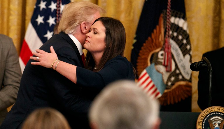 President Trump hugs White House press secretary Sarah Sanders as he pauses from speaking about second chance hiring to publicly thank the outgoing press secretary in the East Room of the White House in Washington. 