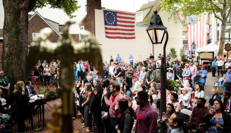 Immigrants raise their right hands and take the oath of citizenship of the United States at the Betsy Ross House in Philadelphia, during a naturalization ceremony on Flag Day, Friday, June 14, 2019. 