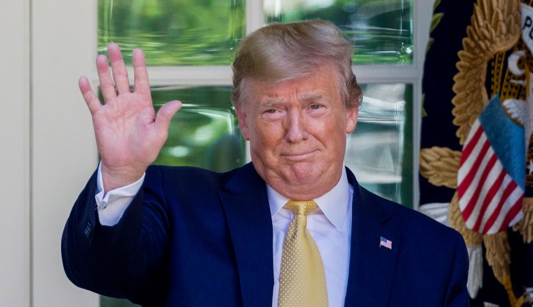 President Trump waves as he departs after speaking in the Rose Garden of the White House in Washington. 
