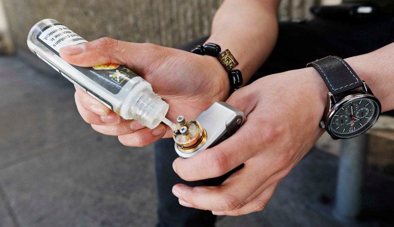 A man refills his electronic cigarette with vaping liquid in San Francisco.