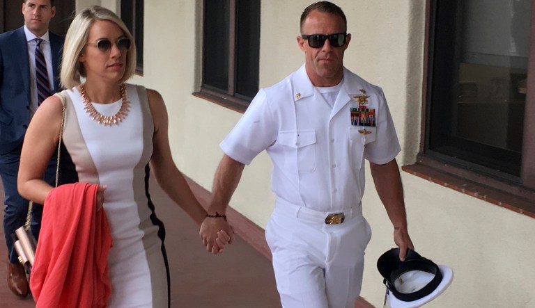 Navy Special Operations Chief Edward Gallagher, right, walks with his wife, Andrea Gallagher as they arrive to military court on Naval Base San Diego, Tuesday, June 18, 2019, in San Diego. Jury selection continued Tuesday morning in the court-martial of the decorated Navy SEAL, who is accused of stabbing to death a wounded teenage Islamic State prisoner and wounding two civilians in Iraq in 2017. He has pleaded not guilty to murder and attempted murder, charges that carry a potential life sentence.