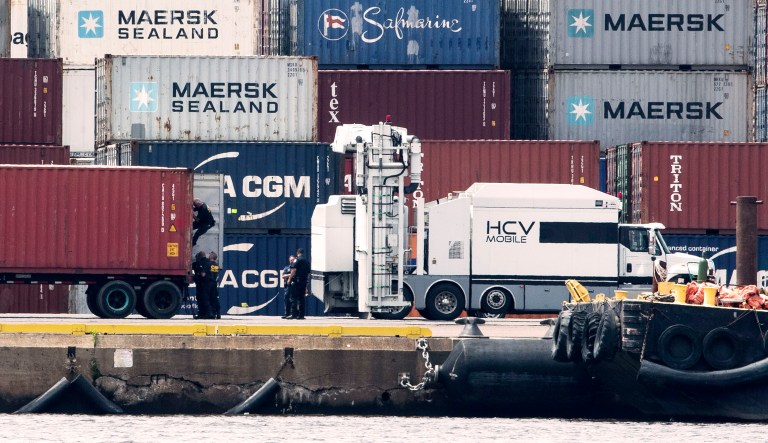 Authorities search a container along the Delaware River in Philadelphia.