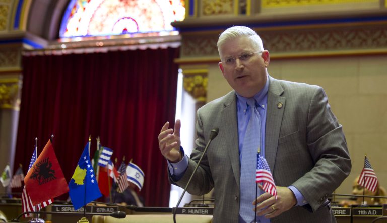 In this March 22, 2016 photo, Assemblyman Michael Kearns speaks in the Assembly Chamber at the Capitol in Albany, N.Y. Kearns, who is now the Erie County Clerk, says he'll refuse to grant driver's licenses to immigrants who entered the U.S. illegally, despite the state's passage of a law allowing it. 