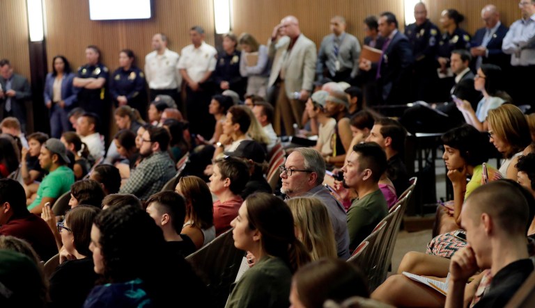 Protesters angered by a video of Phoenix officers who pointed guns and yelled obscenities at a black family they suspected of shoplifting gather inside City Council chambers, Wednesday, June 19, 2019, in Phoenix to demand reforms. 