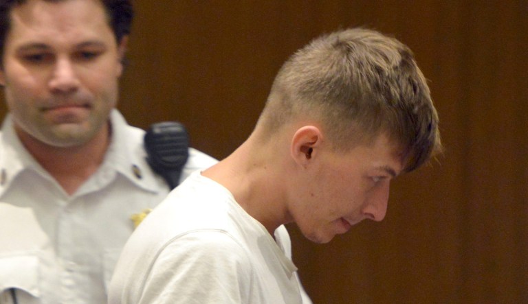 Volodymyr Zhukovskyy, 23, of West Springfield, is escorted into the courtroom.