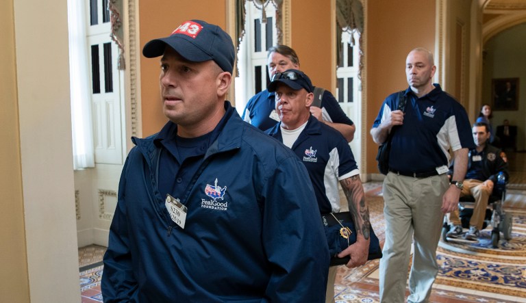 Sept. 11 first responders Ret. Lt. Michael O'Connell, from left, John Feal and other first responders walk on Capitol Hill for a meeting.
