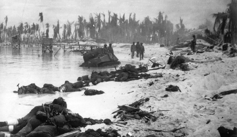 FILE - In this Nov. 1943 file photo, sprawled bodies are seen on the beach of Tarawa atoll testifying to the ferocity of the battle for this stretch of sand during the U.S. invasion of the Gilbert Islands. 