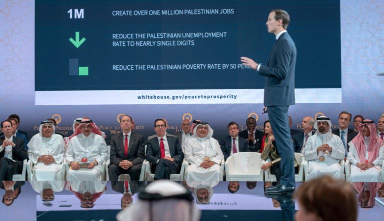 In this Tuesday, June 25, 2019, photo released by Bahrain News Agency, U.S. Treasury Secretary Steven Mnuchin, fifth from left, and Bahrain Crown Prince Salman bin Hamad Al Khalifa, sixth from left, listen to White House senior adviser Jared Kushner, standing, during the opening session of the "Peace to Prosperity" workshop in Manama, Bahrain. 