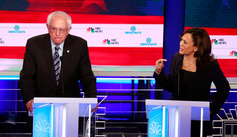 Sens. Bernie Sanders and Kamala Harris participate in a debate.