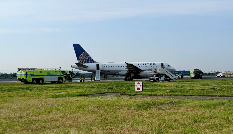 This photo provided by John Murray shows a United flight sitting on the runway after making an emergency landing, Saturday, June 29, 2019 at Newark Liberty Airport in Newark, N.J.