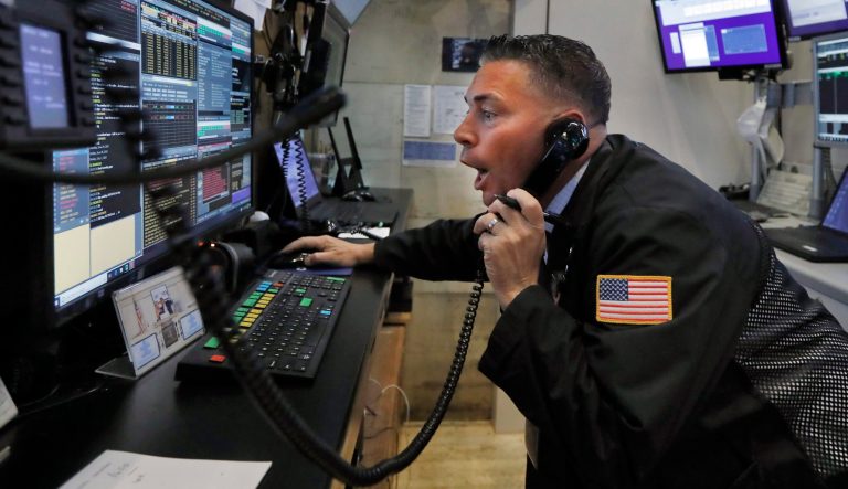 Trader Jonathan Muller works in his booth on the floor of the New York Stock Exchange, Monday, July 1, 2019. 