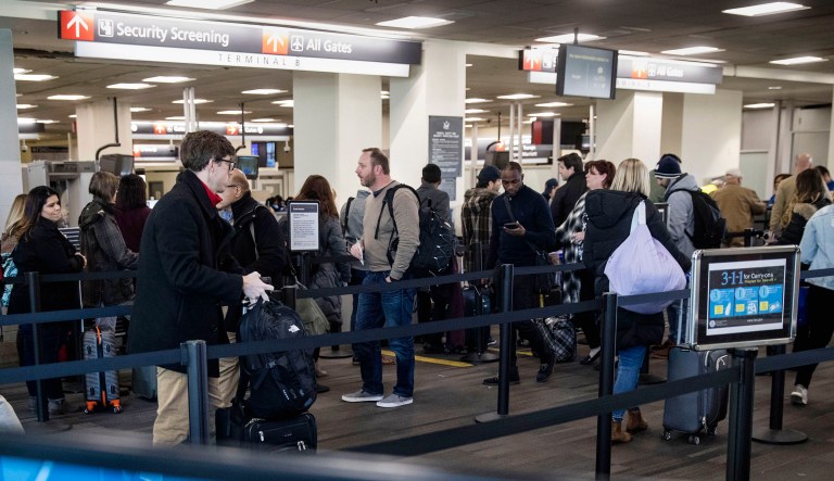 Passengers wait in line at a Transportation Security Administration checkpoint at the Philadelphia International Airport in Philadelphia.