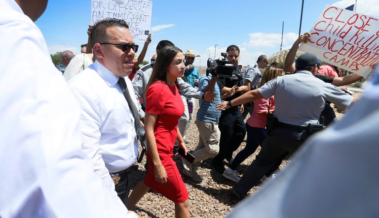 U.S. Rep. Alexandria Ocasio-Cortez, D-New York, is escorted back to her vehicle after she speaks at the Border Patrol station in Clint about what she saw at area border facilities Monday, July 1, at the station in Clint. 