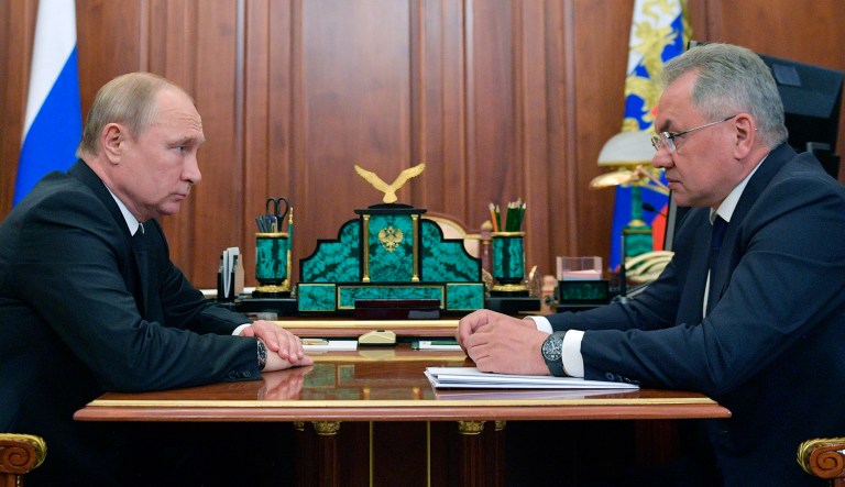 Russian President Vladimir Putin, left, listens to Russian Defense Minister Sergei Shoigu during their meeting in the Kremlin in Moscow, Russia, on Tuesday.