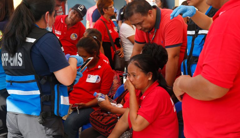 Medics attend to supporters of former Philippine First Lady Imelda Marcos outside a sports arena after falling ill during the 90th birthday celebration of the flamboyant wife of the late dictator Ferdinand Marcos Wednesday, July 3, 2019, in Manila, Philippines. 